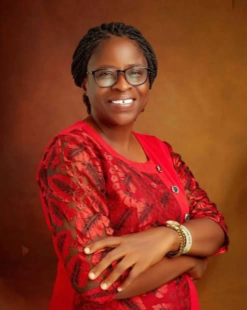Esther Oduntan PhD, researcher and educator, in a red outfit